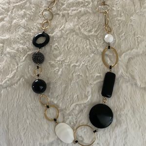 Gold tone circle necklace with some black and white plastic beads